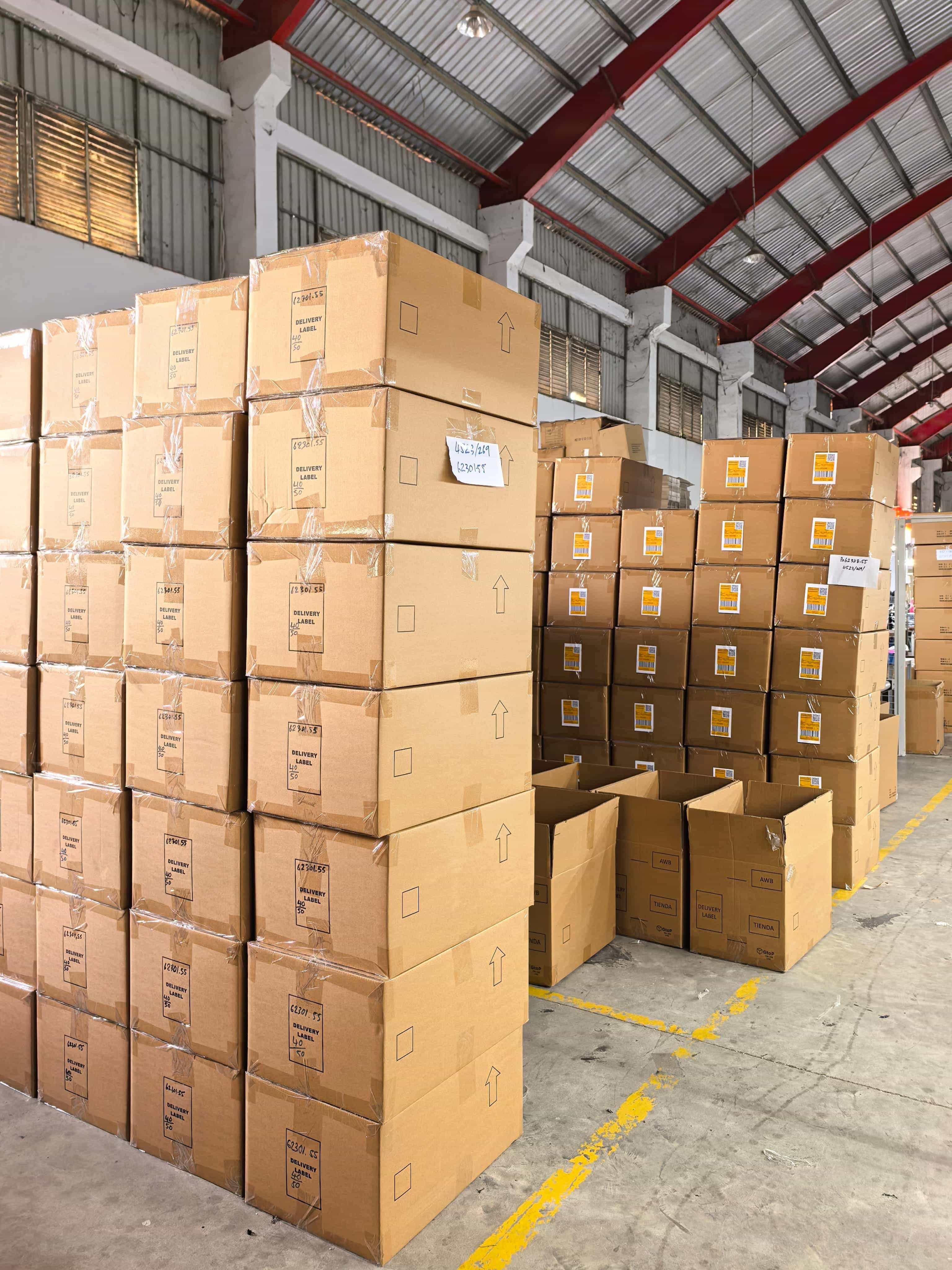 Apparel shipment cartons organized inside Cambodia factory facility
