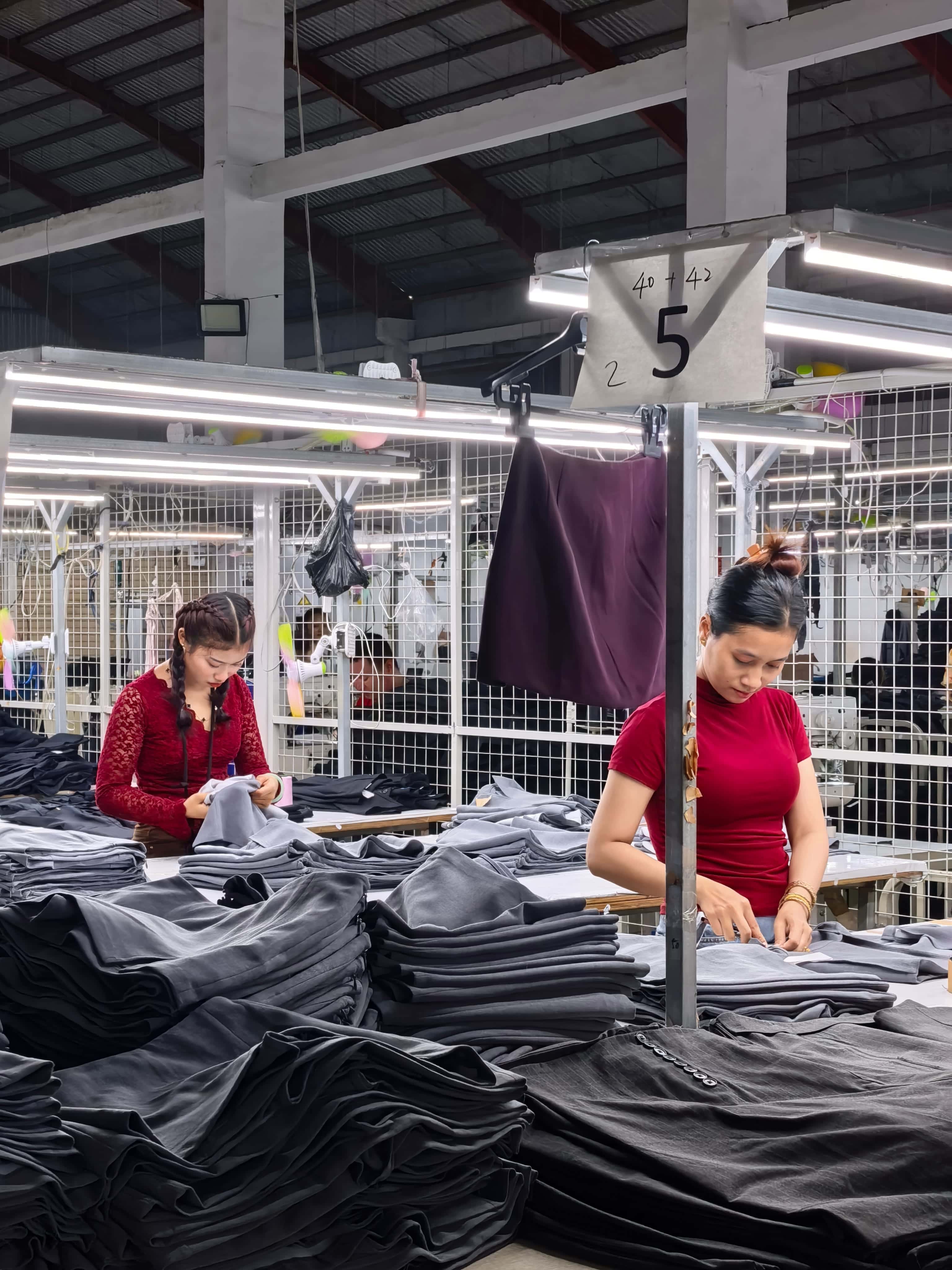 Production team working on garment lines in Southeast Asia factory